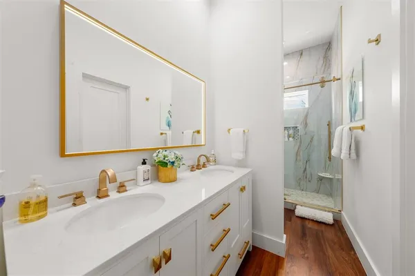 a bathroom with a sink double vanity and a mirror