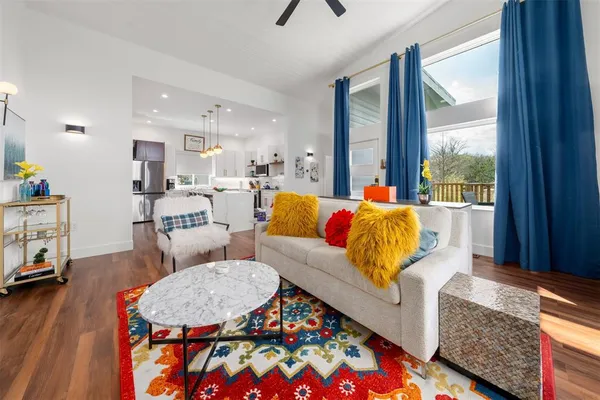 a living room with furniture and a floor to ceiling window