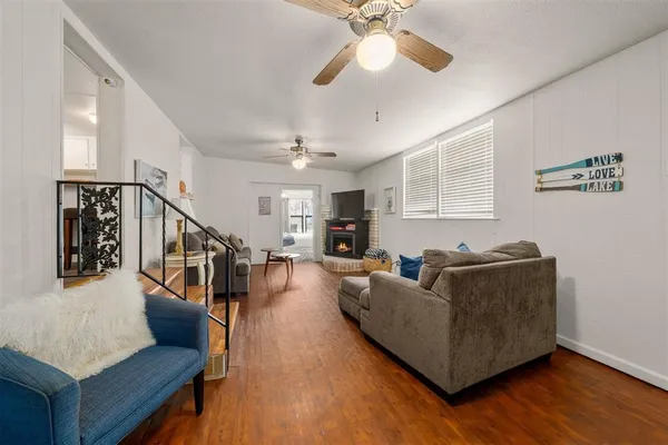 a living room with furniture and a wooden floor