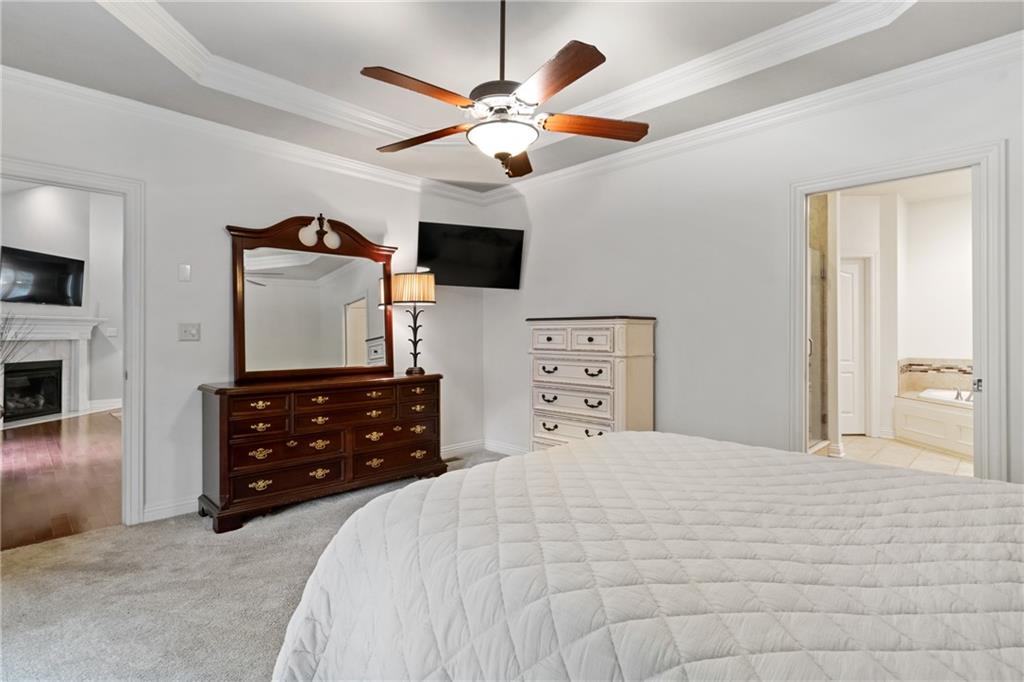 1737 Waterleaf Drive Sewickley, PA 15143 - Photo 15 of 34 a bedroom with a bed a chandelier and a flat tv screen