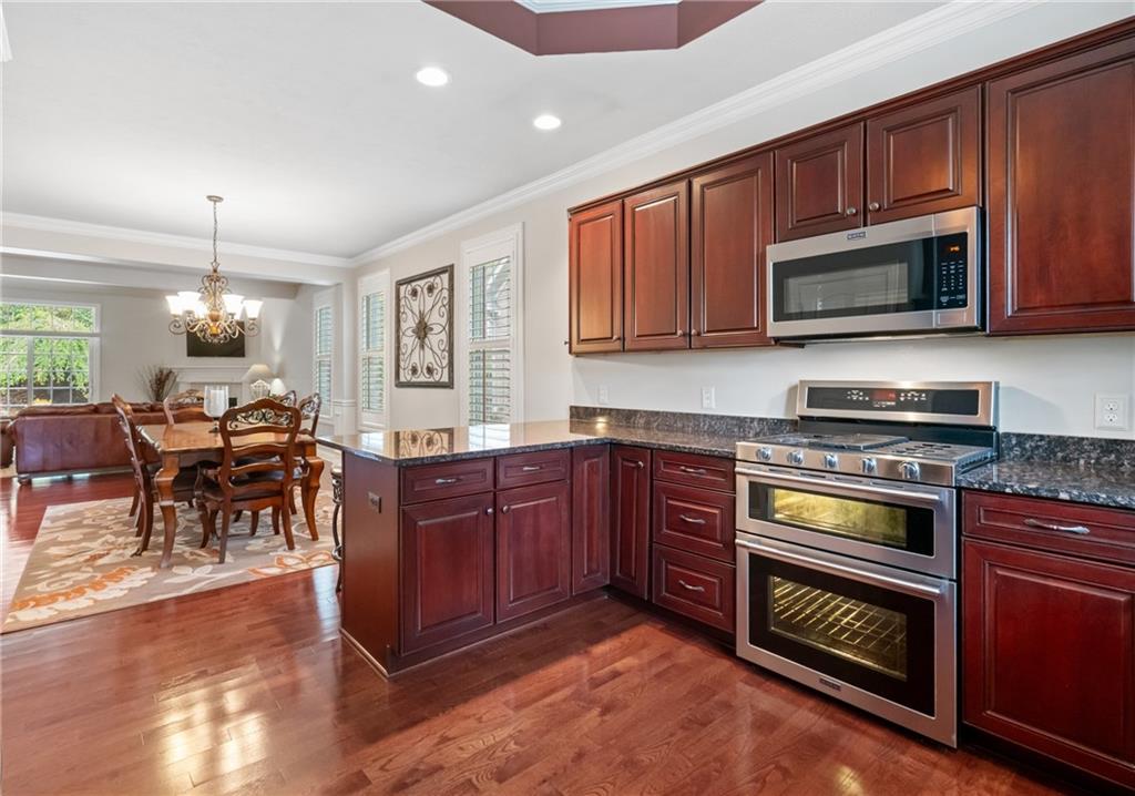 1737 Waterleaf Drive Sewickley, PA 15143 - Photo 8 of 34 a kitchen with stainless steel appliances granite countertop a stove microwave and cabinets