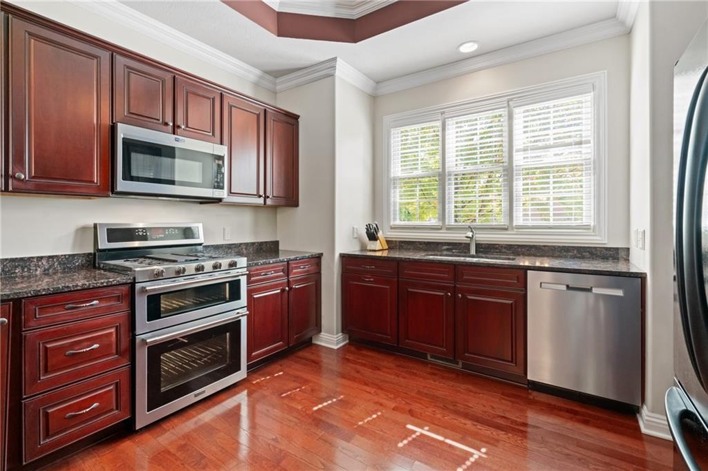 1737 Waterleaf Drive Sewickley, PA 15143 - Photo 9 of 34 a kitchen with stainless steel appliances granite countertop a stove microwave and sink