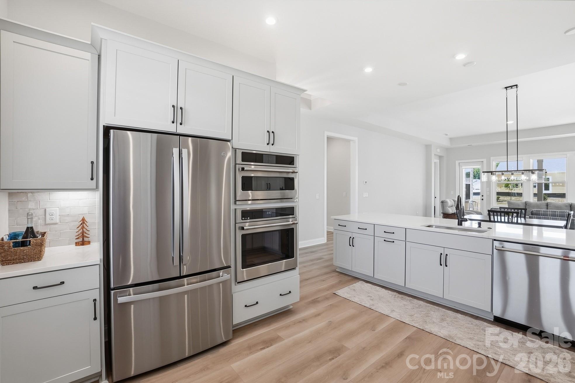 1035 Rabbit Hl Lane Monroe, NC 28110 - Photo 11 of 39 a kitchen with white cabinets and white appliances