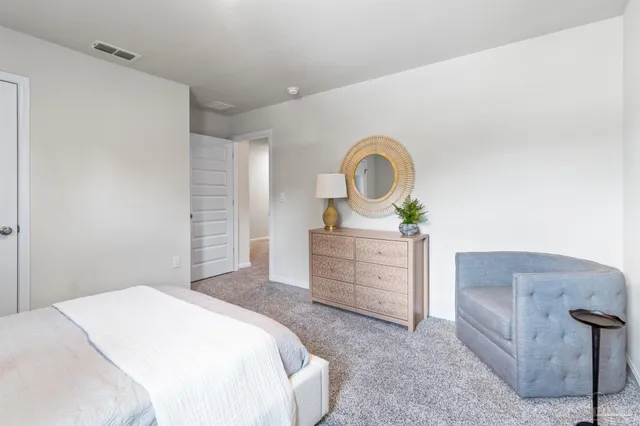 a bedroom with a bed and a dresser