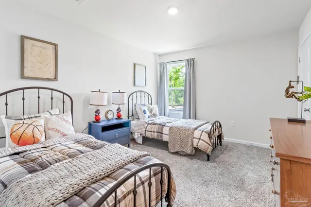 a bedroom with bed and a window