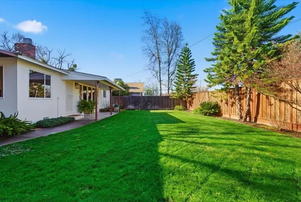 a front view of house with yard and green space