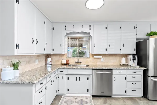 a kitchen with a stove a sink and a refrigerator