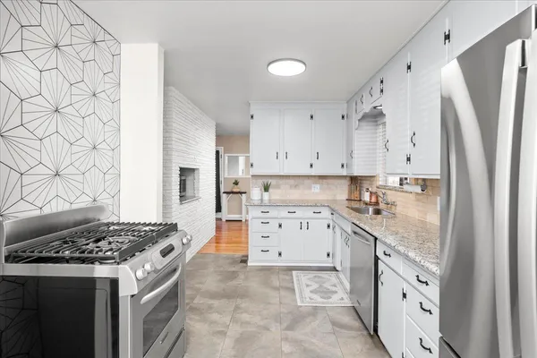 a hallway with a stove and a microwave oven