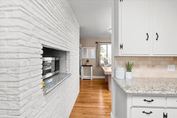 a living room with a table chairs and a kitchen view