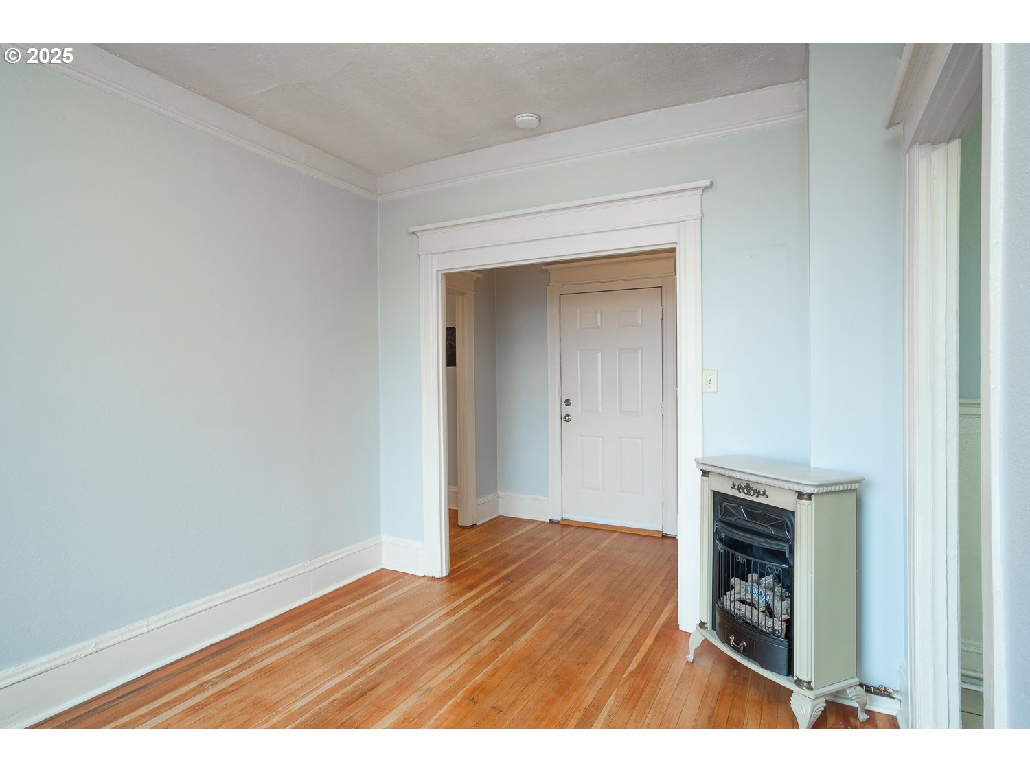 2109 Northwest Irving Street, Unit 407 Portland, OR 97210 - Photo 12 of 17 a view of an empty room and wooden floor