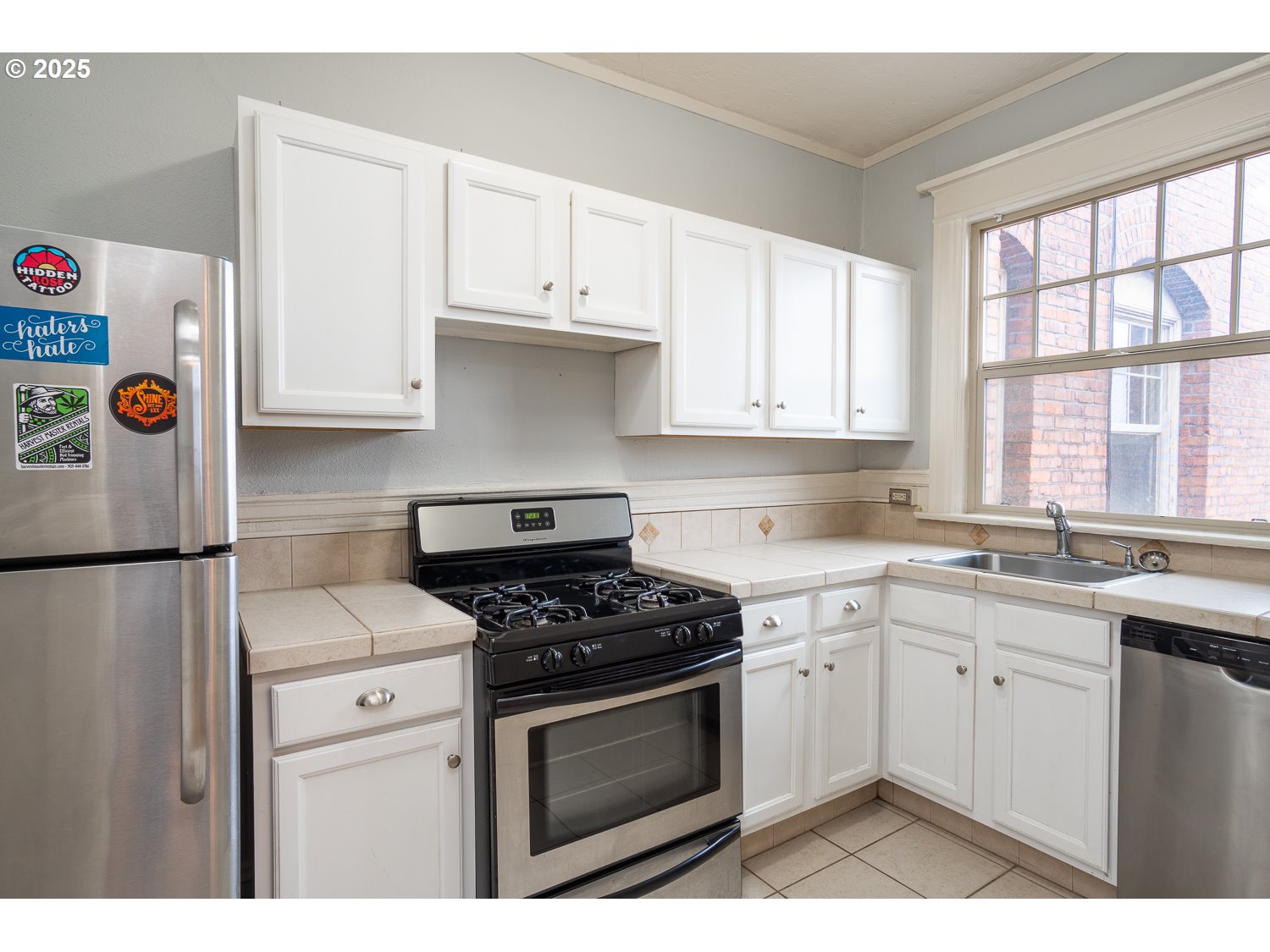 2109 Northwest Irving Street, Unit 407 Portland, OR 97210 - Photo 13 of 17 a kitchen with a white cabinets and white appliances