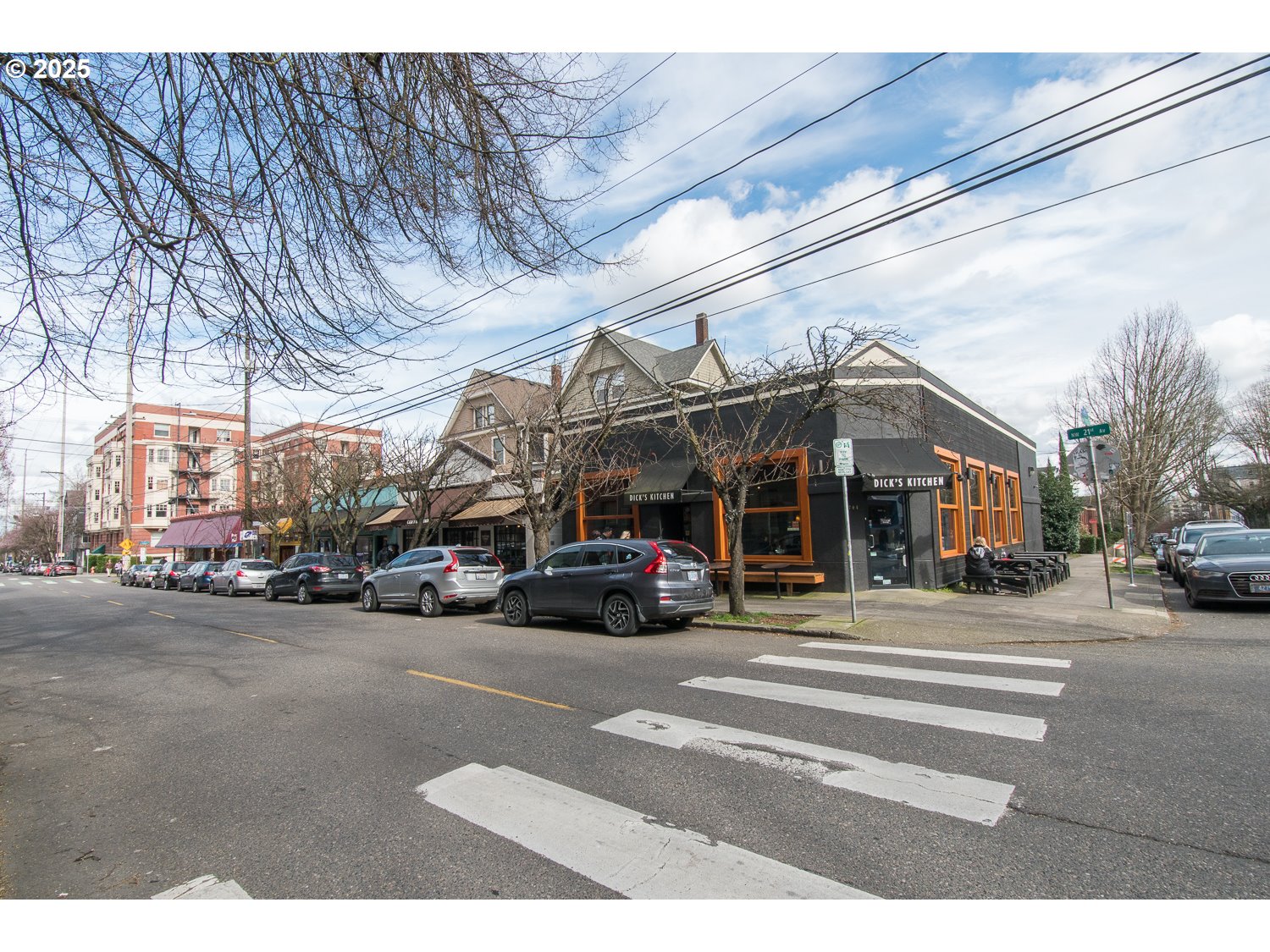 2109 Northwest Irving Street, Unit 407 Portland, OR 97210 - Photo 17 of 17 a view of a cars parked in front of a building