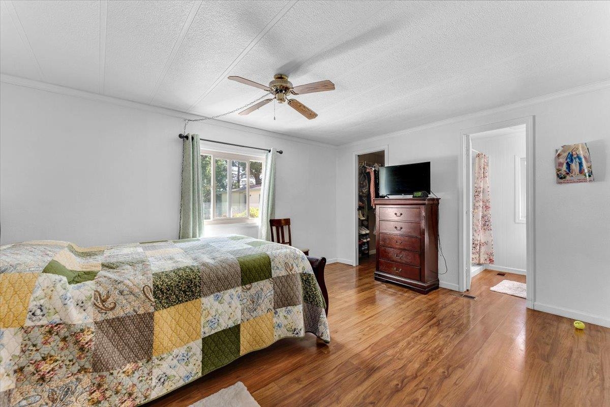 350 Gilmore Road Red Bluff, CA 96080 - Photo 15 of 27 a bedroom with a bed television on desk and a window