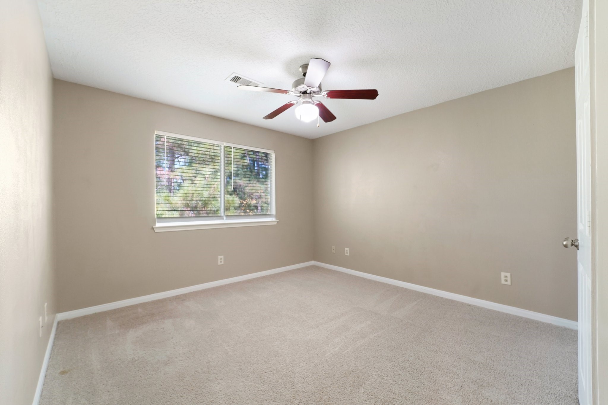 100 Westpark Drive, Unit 5 Conroe, TX 77304 - Photo 12 of 23 an empty room with windows and fan