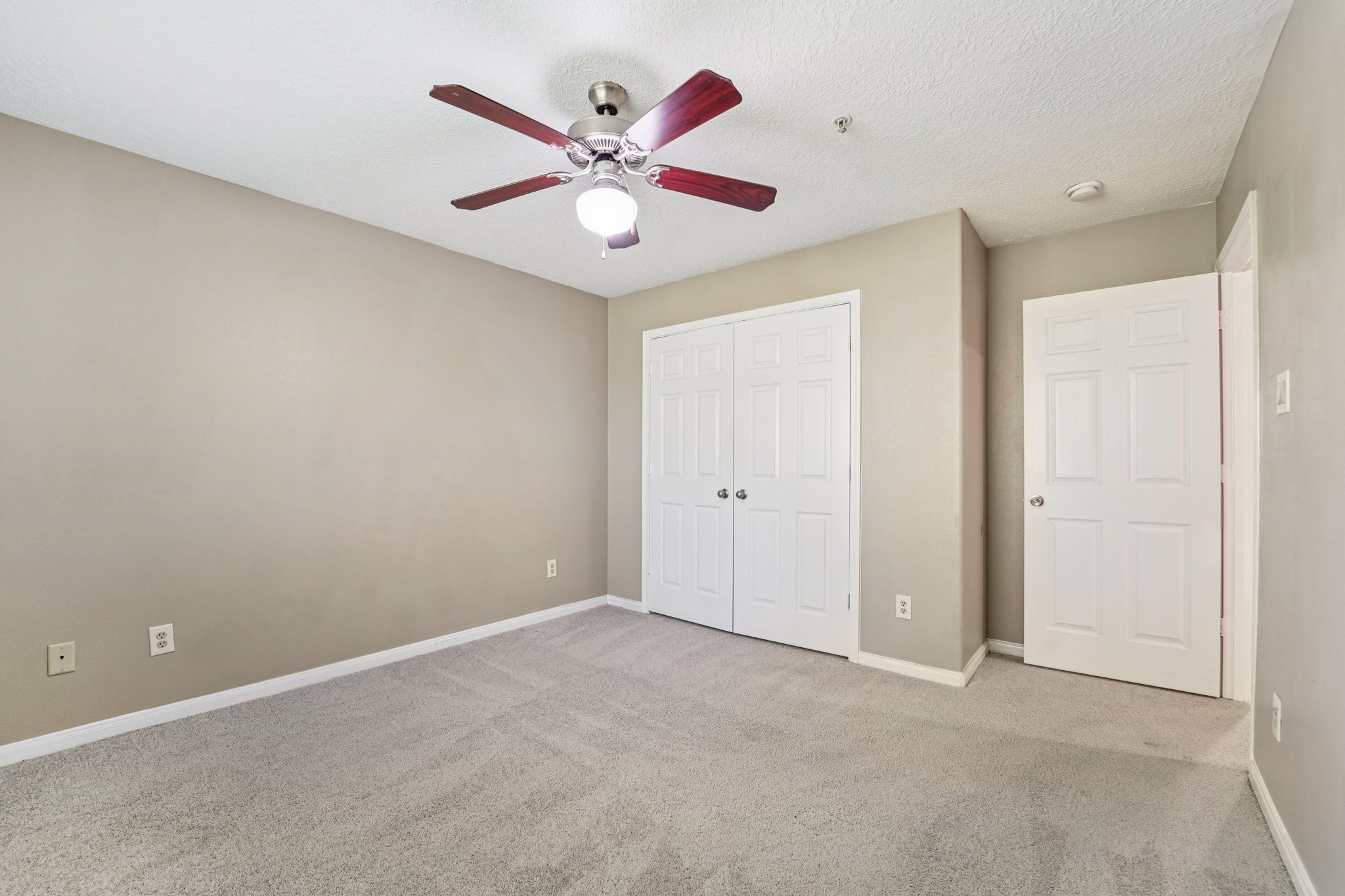 100 Westpark Drive, Unit 5 Conroe, TX 77304 - Photo 13 of 23 an empty room with a ceiling fan and a window