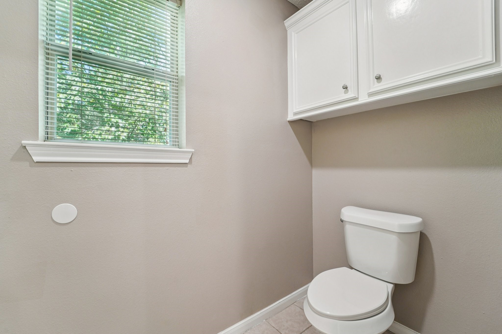 100 Westpark Drive, Unit 5 Conroe, TX 77304 - Photo 17 of 23 a white toilet sitting next to a window