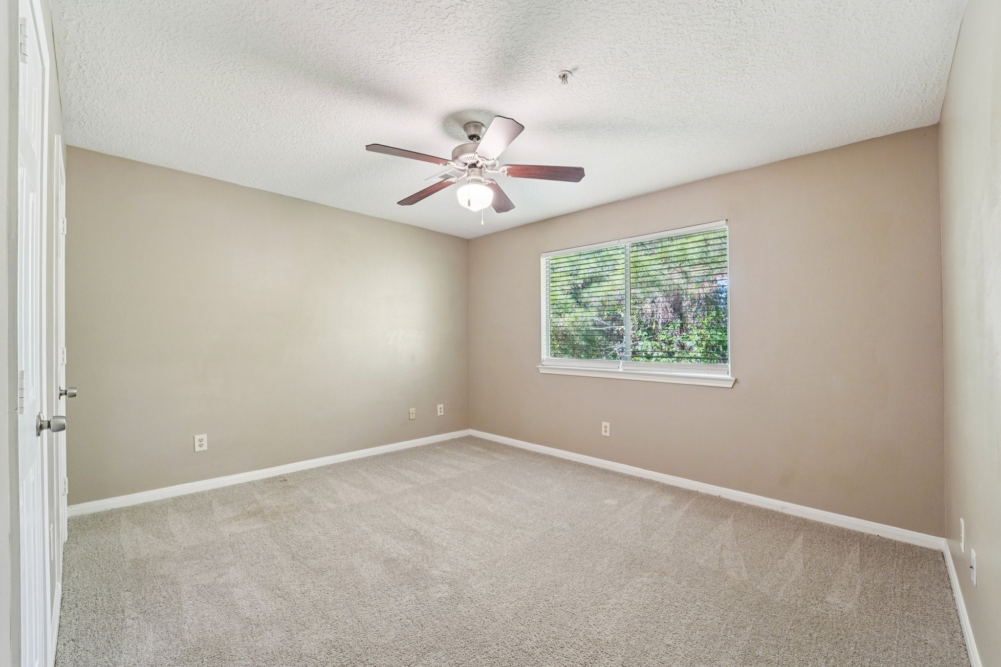 100 Westpark Drive, Unit 5 Conroe, TX 77304 - Photo 18 of 23 an empty room with a window and a fan