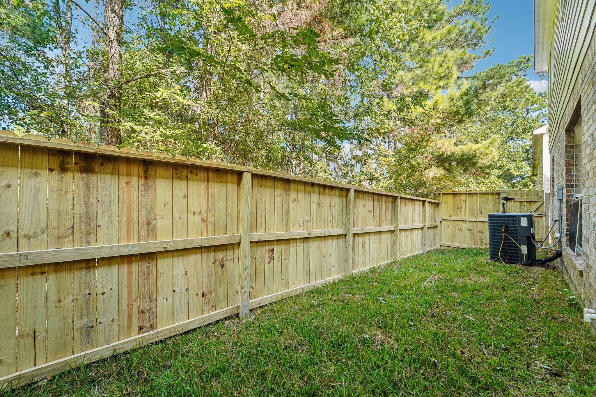 100 Westpark Drive, Unit 5 Conroe, TX 77304 - Photo 22 of 23 a backyard of a house with lawn chairs and iron fence