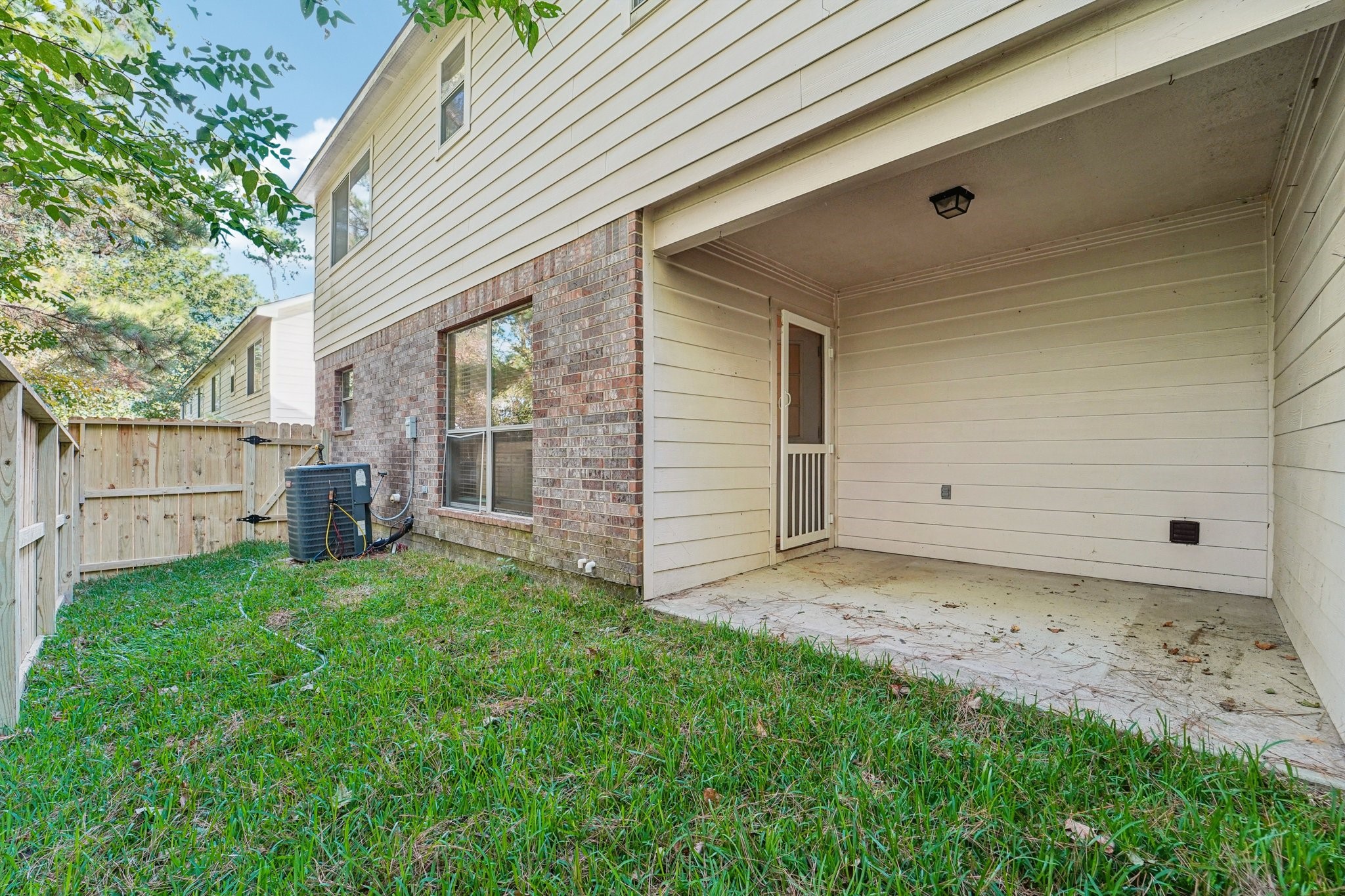 100 Westpark Drive, Unit 5 Conroe, TX 77304 - Photo 23 of 23 a view of a house with backyard and trees