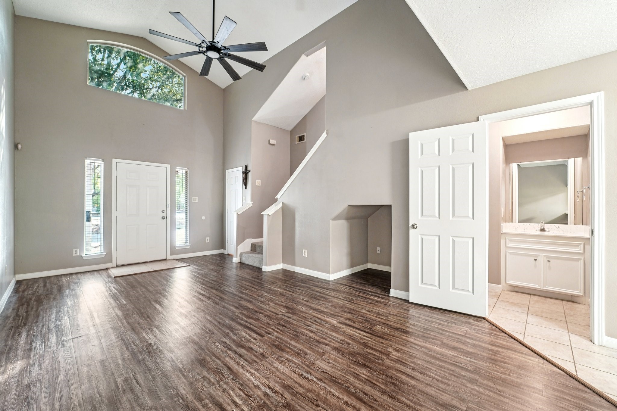 100 Westpark Drive, Unit 5 Conroe, TX 77304 - Photo 4 of 23 a view of an empty room with wooden floor and a window