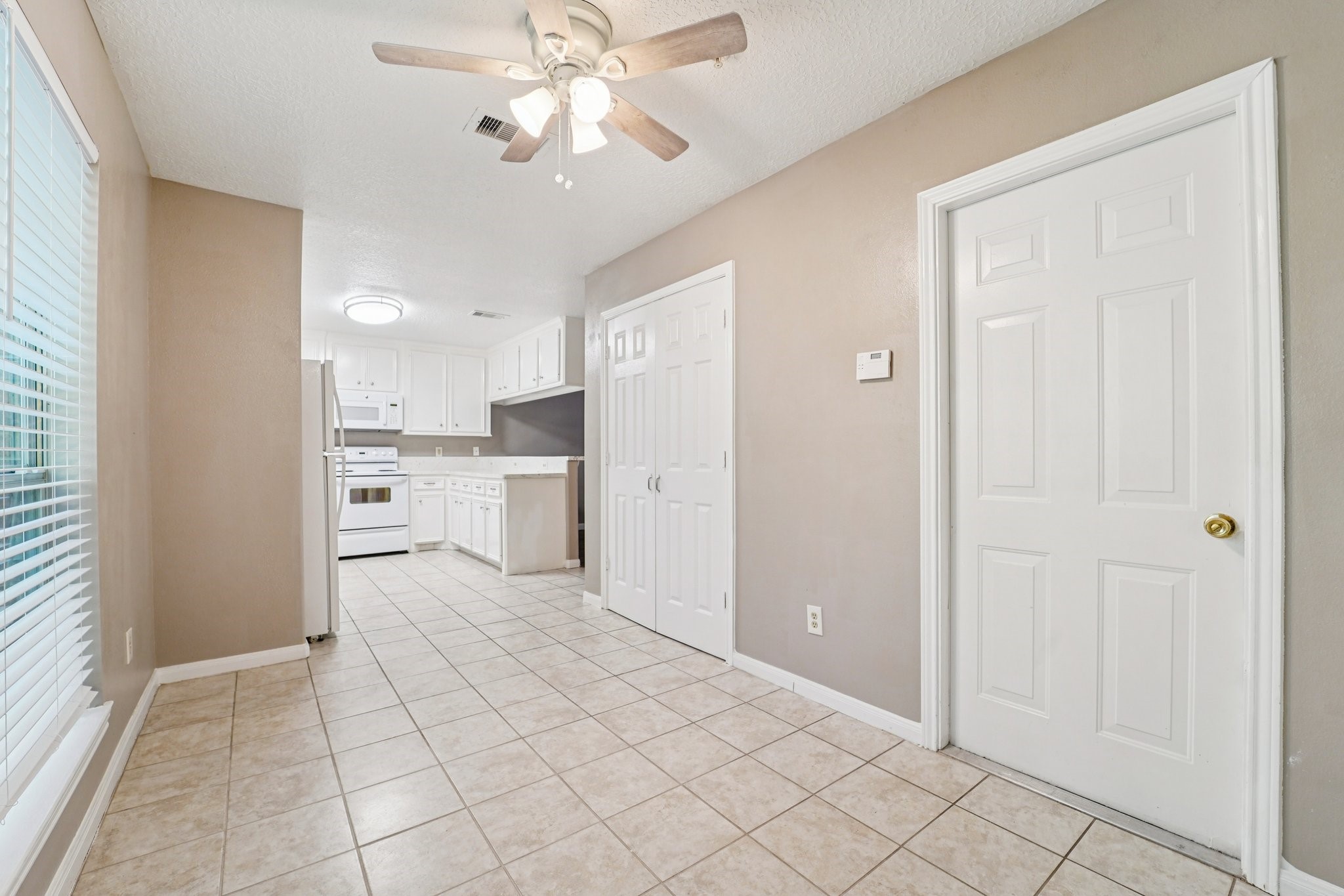 100 Westpark Drive, Unit 5 Conroe, TX 77304 - Photo 9 of 23 a view of a kitchen with a sink and a refrigerator