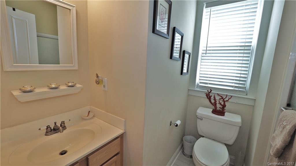 8106 Strandhill Road, Unit 12 Huntersville, NC 28078 - Photo 11 of 24 a bathroom with a sink a toilet and mirror