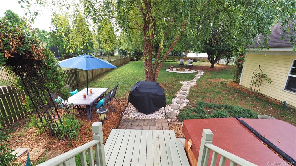 8106 Strandhill Road, Unit 12 Huntersville, NC 28078 - Photo 17 of 24 a view of a patio with table and chairs potted plants with wooden floor