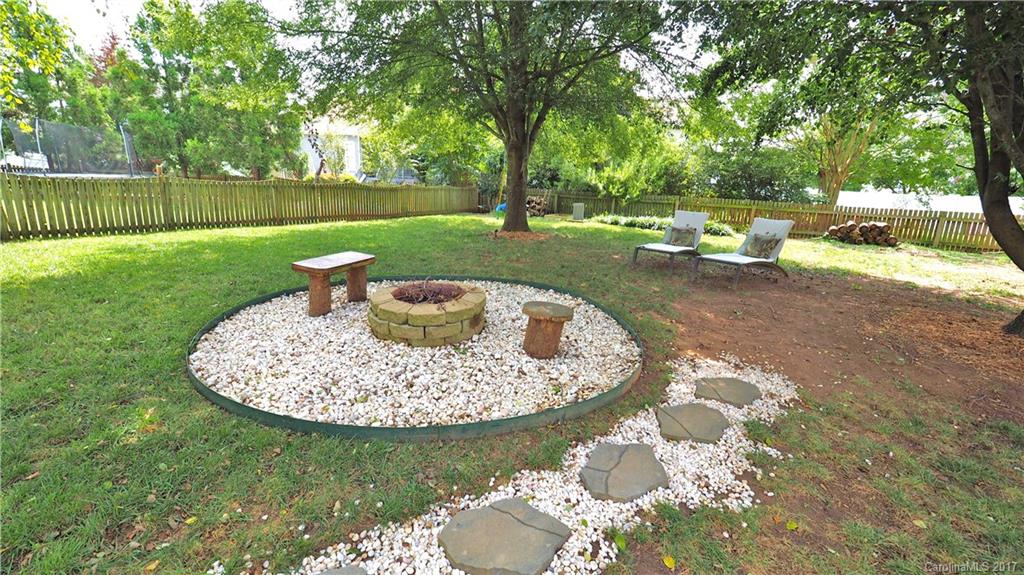 8106 Strandhill Road, Unit 12 Huntersville, NC 28078 - Photo 20 of 24 a view of a backyard with a garden and outdoor seating