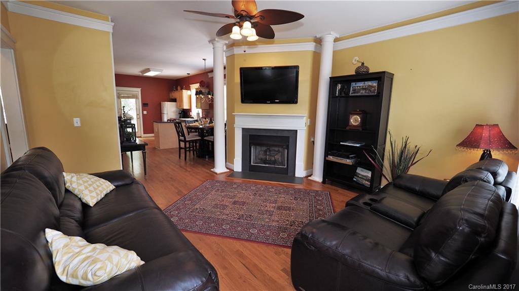 8106 Strandhill Road, Unit 12 Huntersville, NC 28078 - Photo 4 of 24 a living room with furniture a fireplace and a flat screen tv