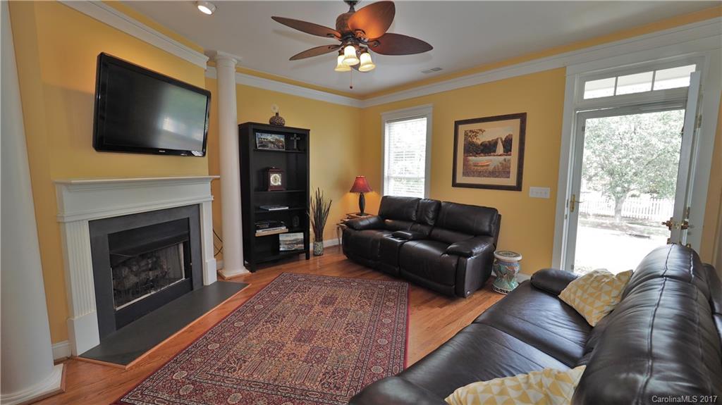 8106 Strandhill Road, Unit 12 Huntersville, NC 28078 - Photo 5 of 24 a living room with furniture a flat screen tv and a fireplace