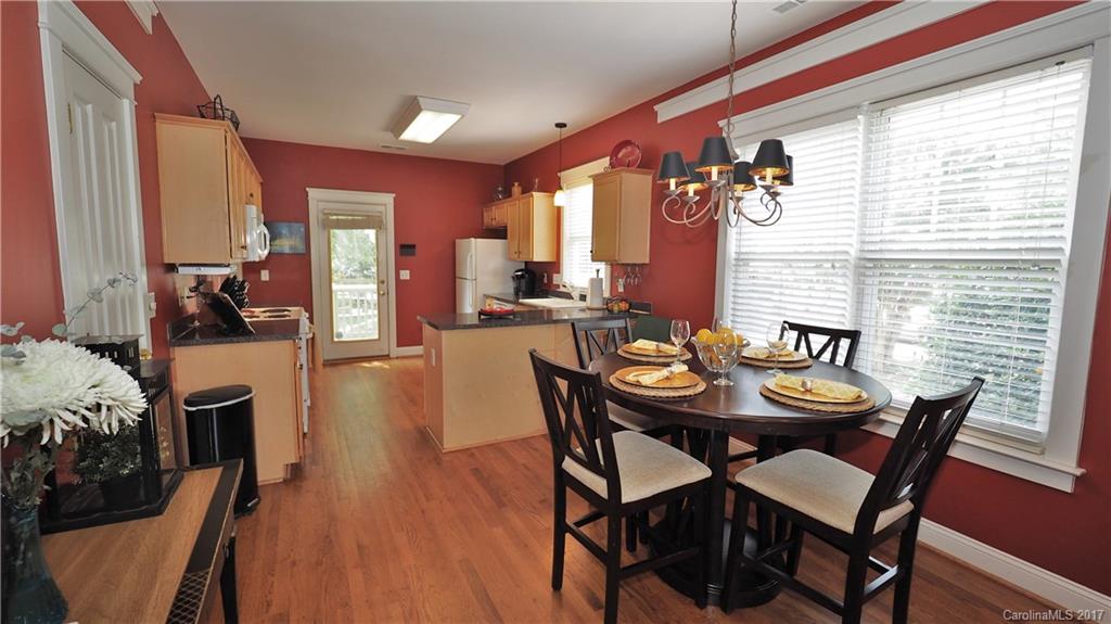 8106 Strandhill Road, Unit 12 Huntersville, NC 28078 - Photo 6 of 24 a view of a dining room with furniture and wooden floor