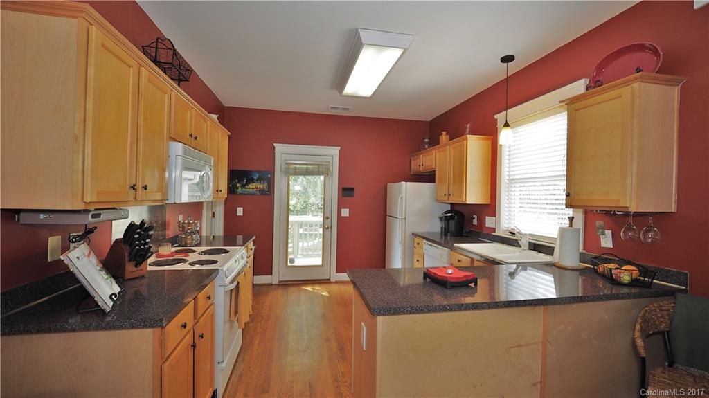 8106 Strandhill Road, Unit 12 Huntersville, NC 28078 - Photo 8 of 24 a kitchen that has a sink and a stove