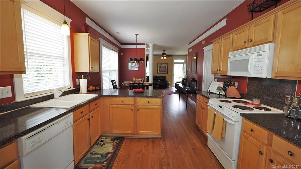 8106 Strandhill Road, Unit 12 Huntersville, NC 28078 - Photo 9 of 24 a kitchen with stainless steel appliances a stove sink and cabinets