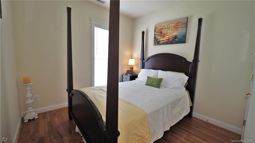 8106 Strandhill Road, Unit 12 Huntersville, NC 28078 - Photo 10 of 24 a bedroom with a bed and wooden floor