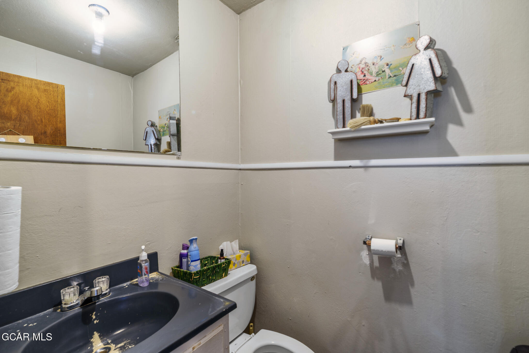104 3rd Street Kremmling, CO 80459 - Photo 13 of 71 a bathroom with a sink mirror and vanity