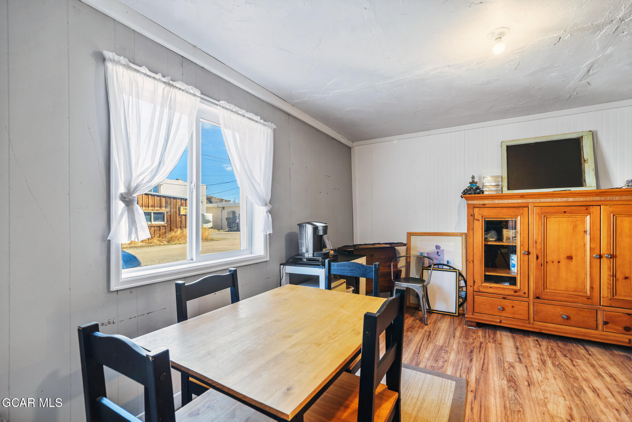 104 3rd Street Kremmling, CO 80459 - Photo 16 of 71 a view of a dining room with furniture window and wooden floor