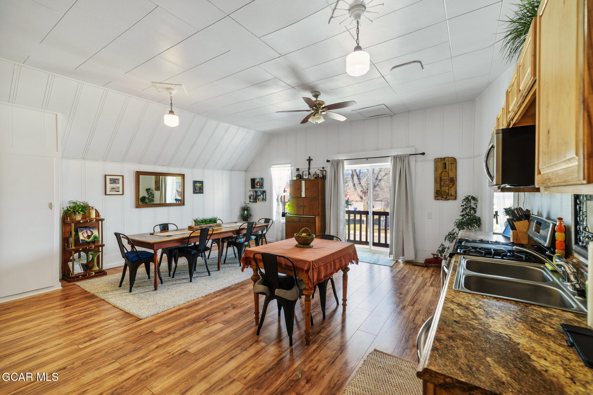 104 3rd Street Kremmling, CO 80459 - Photo 38 of 71 a view of a dining room with furniture a chandelier and wooden floor