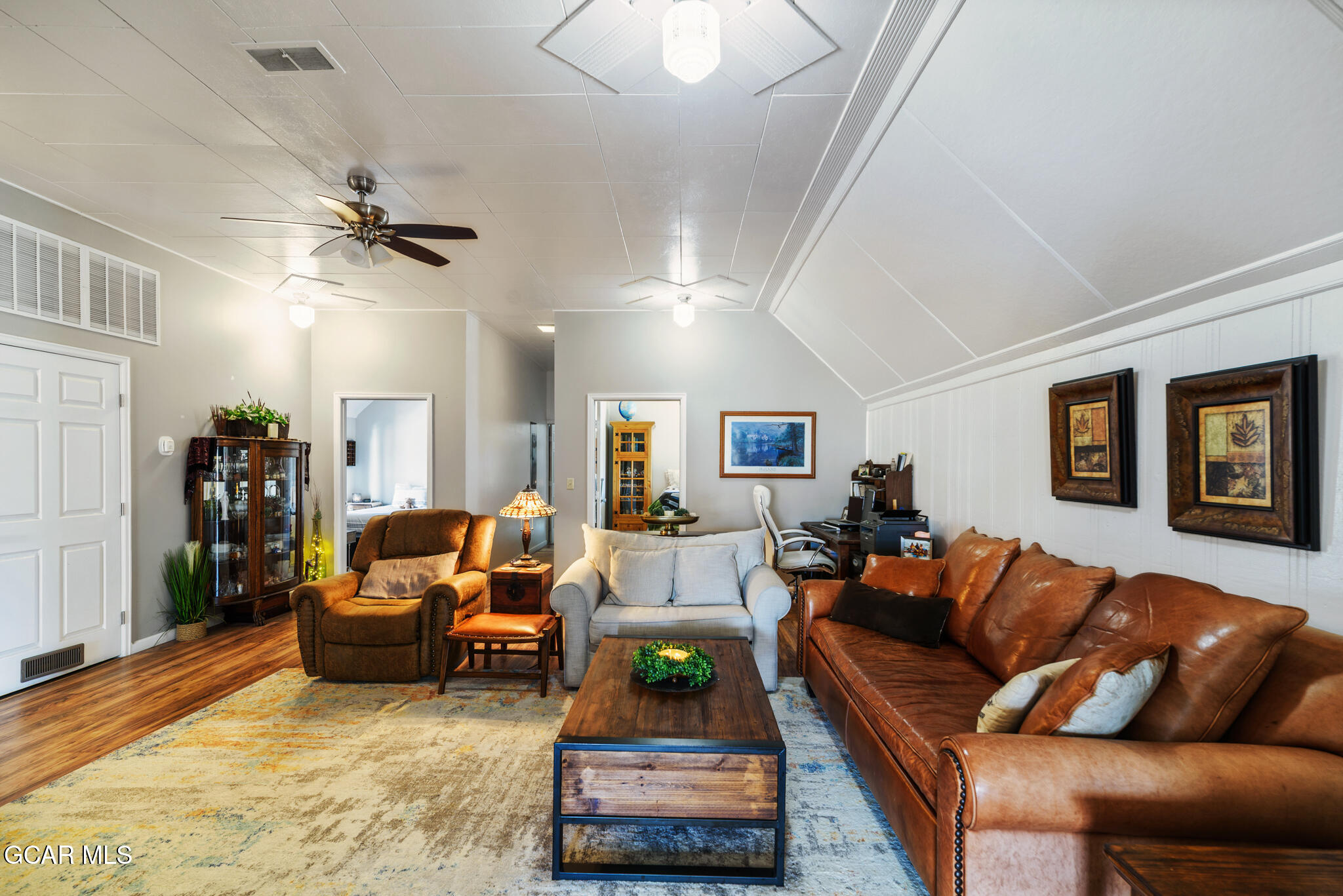 104 3rd Street Kremmling, CO 80459 - Photo 47 of 71 a living room with furniture and a chandelier