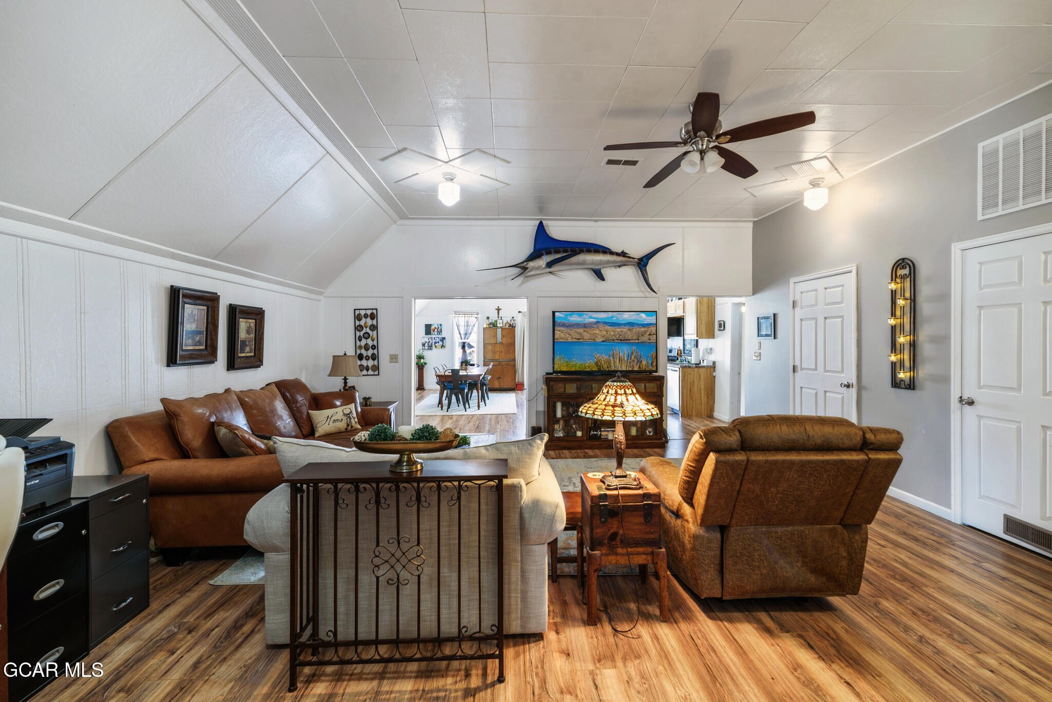 104 3rd Street Kremmling, CO 80459 - Photo 52 of 71 a living room with furniture a ceiling fan and a rug