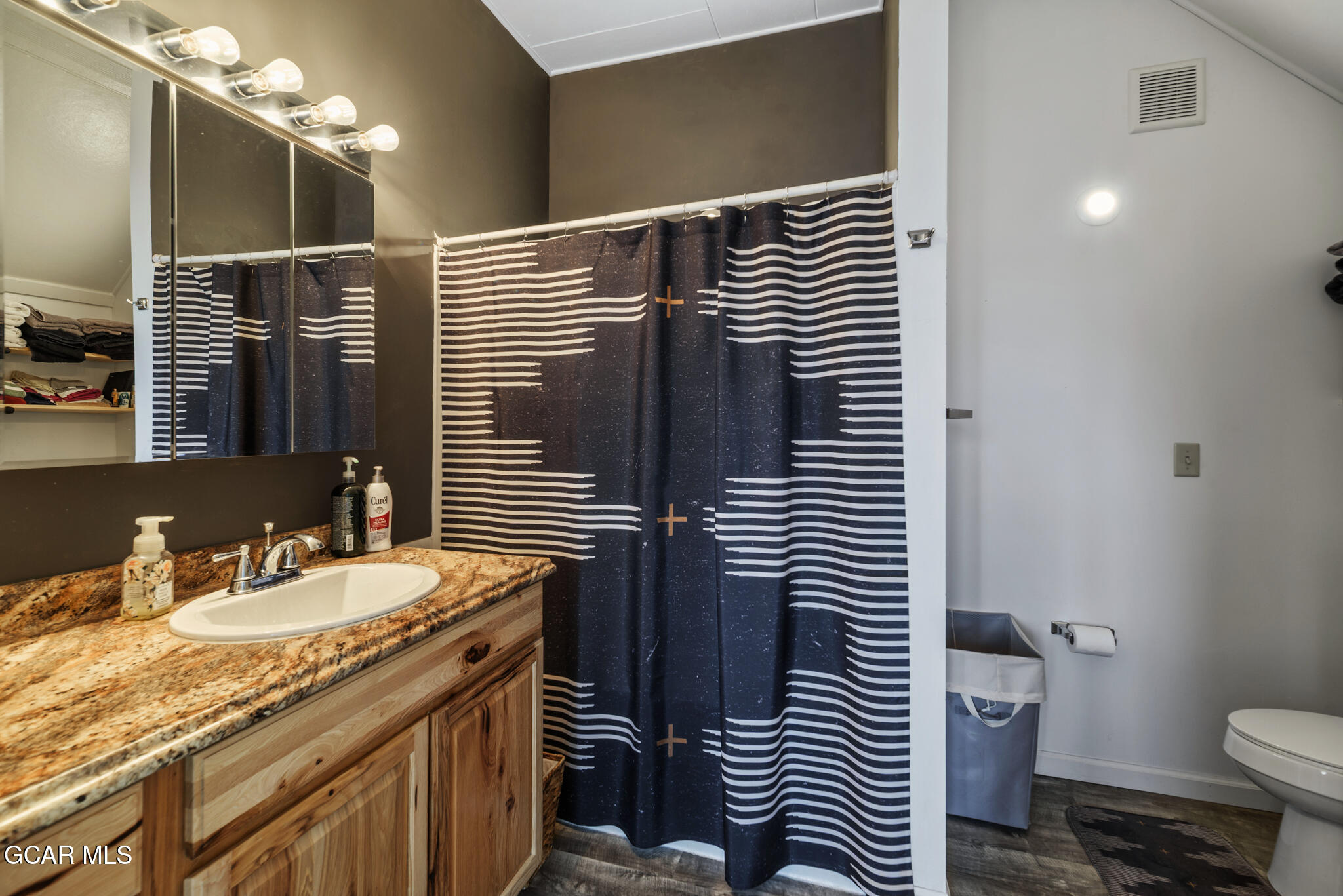 104 3rd Street Kremmling, CO 80459 - Photo 63 of 71 a bathroom with a granite countertop sink toilet and shower
