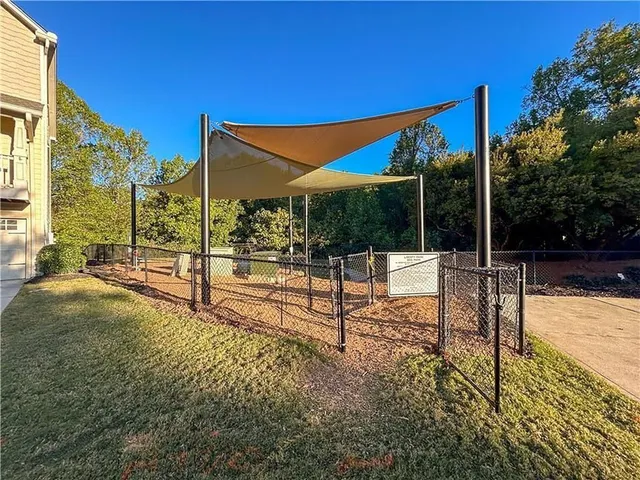 a front view of a house with a garden and trees