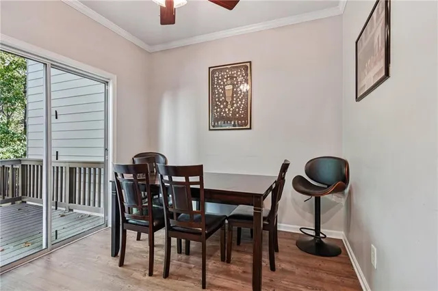 a view of a dining room with furniture and a large window