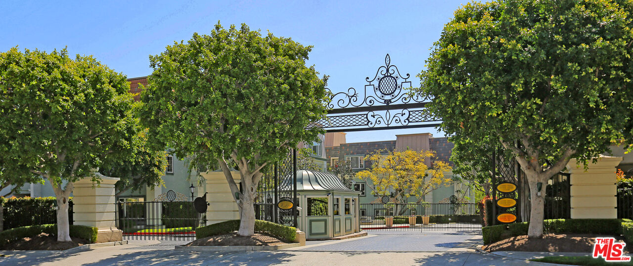 a sign board with buildings in the background