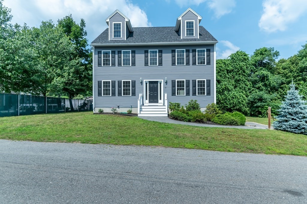 a front view of a house with a yard