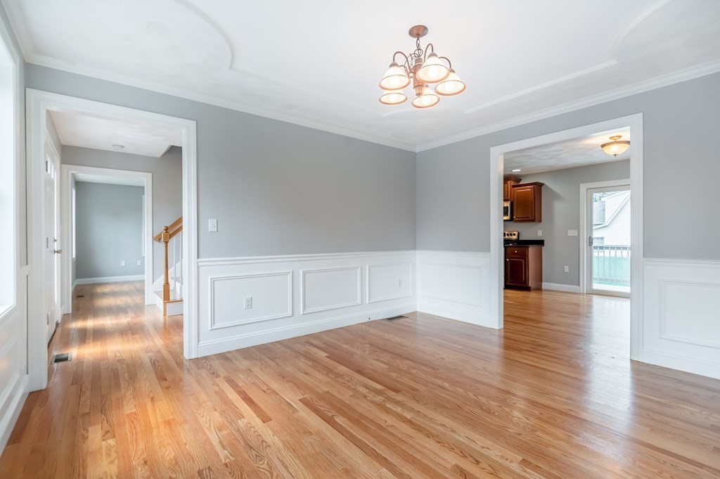 12 Bell Road Tewksbury, MA 01876 - Photo 11 of 26 wooden floor in an empty room with a window