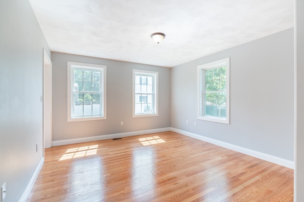 12 Bell Road Tewksbury, MA 01876 - Photo 12 of 26 a view of empty room with wooden floor and fan