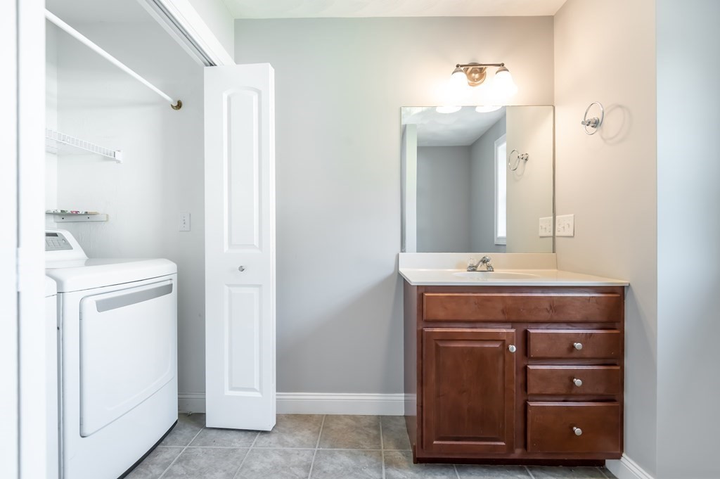 12 Bell Road Tewksbury, MA 01876 - Photo 14 of 26 a bathroom with a sink and a mirror