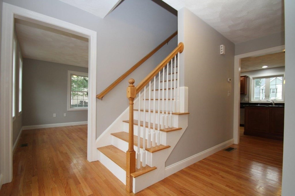 12 Bell Road Tewksbury, MA 01876 - Photo 15 of 26 a view of entryway with wooden floor and stairs