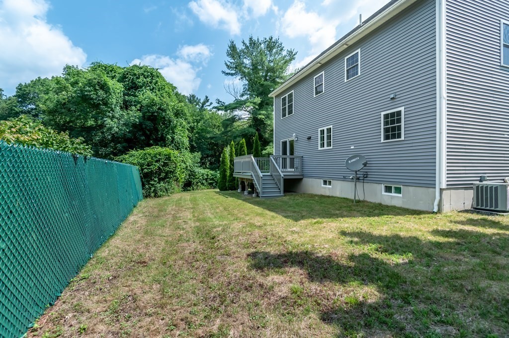 12 Bell Road Tewksbury, MA 01876 - Photo 24 of 26 a backyard of a house with table and chairs