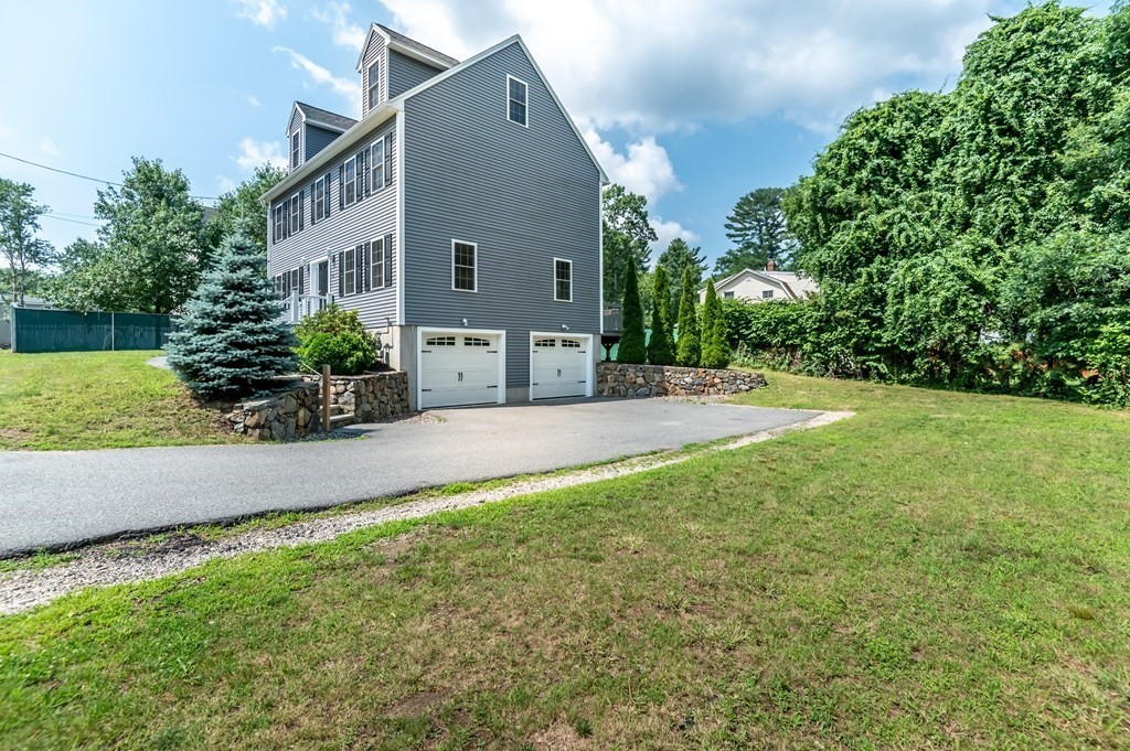 12 Bell Road Tewksbury, MA 01876 - Photo 3 of 26 a front view of a house with a yard